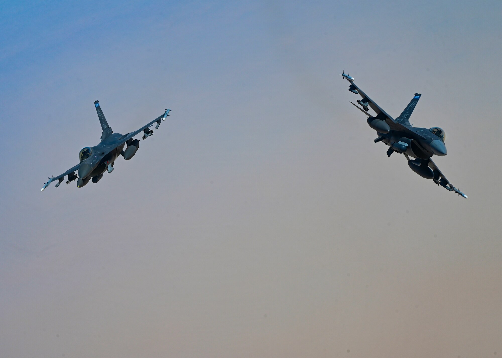 Two U.S. Air Force F-16 Fighting Falcons break away after an air refueling from a KC-135 Stratotanker assigned to the 50th Expeditionary Air Refueling Squadron during exercise Accurate Test 22, within the U.S. Central Command area of responsibility, May 15, 2022. The U.S. continues to prioritize Omani integration and seeks to deepen its partner ties throughout the Middle East. (U.S. Air Force photo by Staff Sgt. Ashley Sokolov)