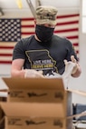 Soldier sorts food into a bag