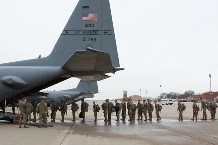 Soldiers lined up to board plane