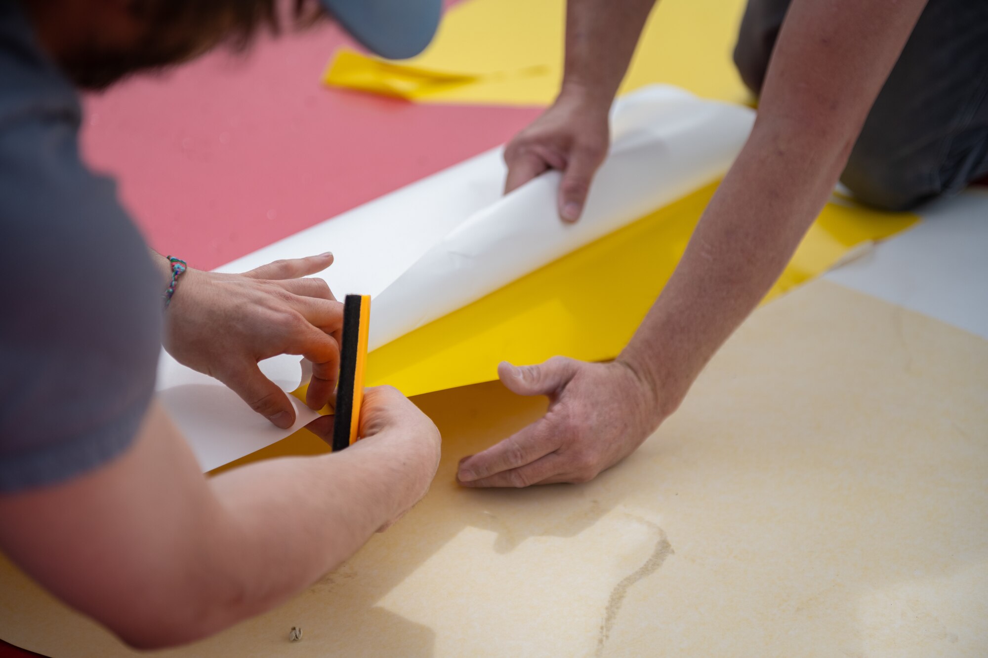 Men work on painting.