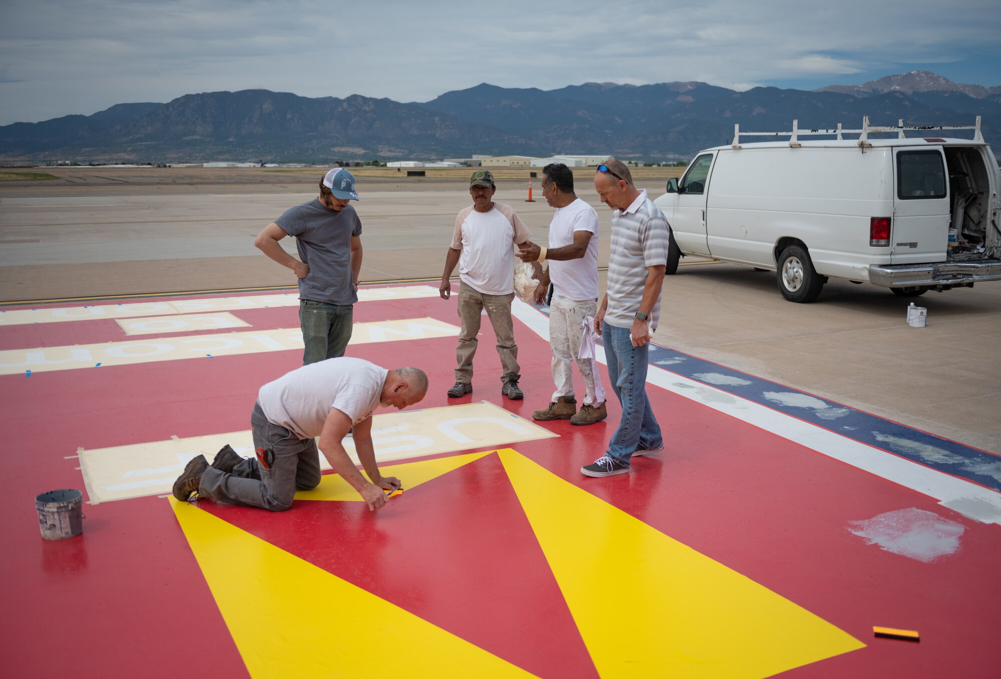 Men work on painting
