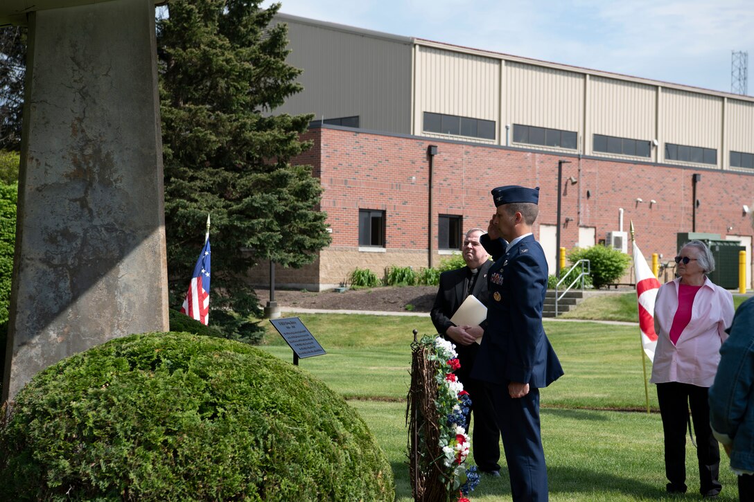 Barnestomers honor the 13 Airmen fallen in flight from the 104th Fighter Wing during the F-100 memorial rededication ceremony, May 20, 2022, at Barnes Air National Guard Base, Massachusetts. The F-100 monument was originally dedicated on May 17, 1987 by the 104FW Chief Master Sergeant’s Council. It continues to serve as a reminder of fallen Airmen’s impact on the unit.(U.S. Air National Guard photo by Staff Sgt. Hanna Smith)