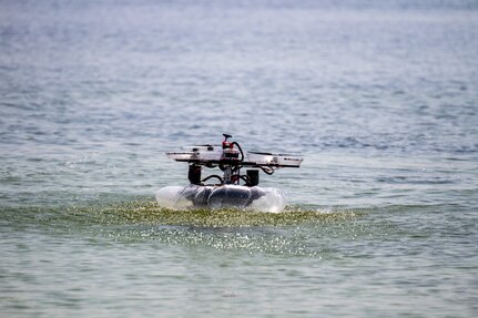 Naval Surface Warfare Center Panama City Division E Department's – “The Swag (SeaWater Air & Ground) Surfers” – amphibious vehicle navigates the second leg of the three part requirement at Naval Support Activity Panama City, Fla., during preliminary trials of the Technical Director's Cup, May 17, 2022. The Landing Craft Air Cushion (LCAC) is such a prominent part of E Department, we wanted to incorporate an air-cushioned vehicle when we heard that the competition would involve an amphibious landing, stated E Department Team Mentor Blake Ivy. (U.S. Navy photo by Bob Lindee)