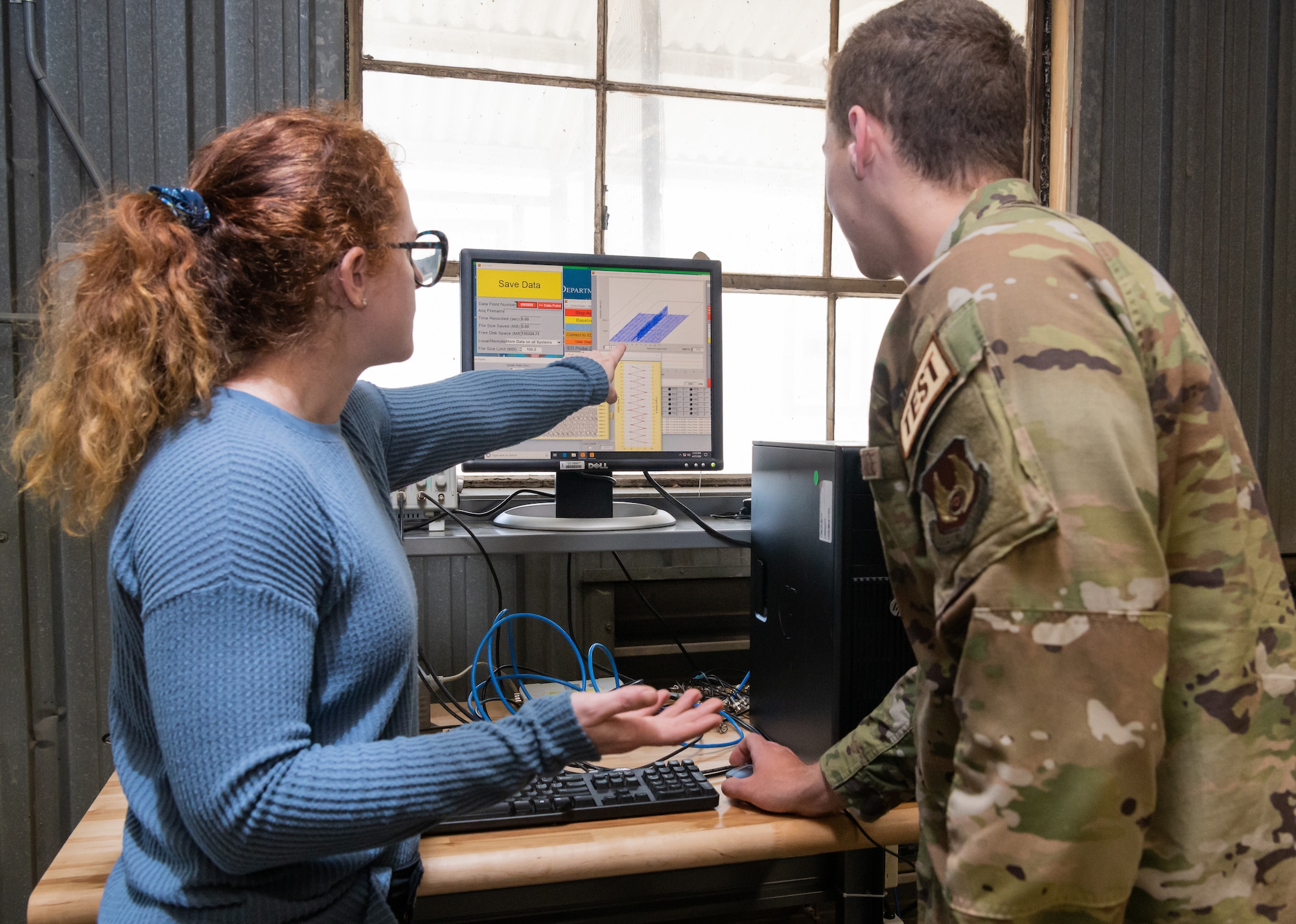Nicole Prieto, a test manager with the 717th Test Squadron, 804th Test Group, Arnold Engineering Development Complex; and 2nd Lt. Paul McCormack, a test engineer with the 717 TS, look at data from a non-interference stress measurement system training environment in the Innovation Center at Arnold Air Force Base.