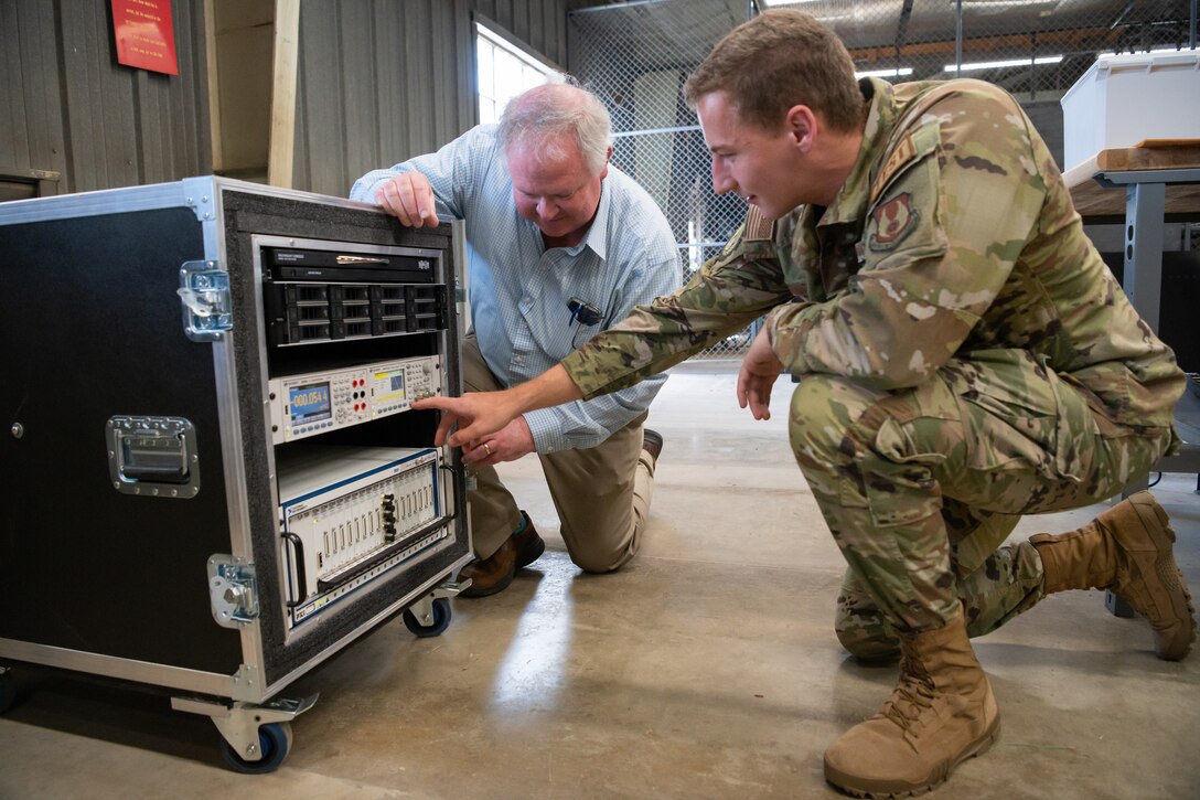 Steve Arnold, technical adviser for the 717th Test Squadron (717 TS), 804th Test Group, Arnold Engineering Development Complex; and 2nd Lt. Paul McCormack, a test engineer with the 717 TS, look at a new capability set up in the Innovation Center at Arnold Air Force Base.