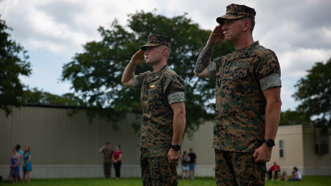 U.S. Marine Corps Lt. Col. Bill Soucie, left, commanding officer, and Sgt. Maj. Phillip Anderson, sergeant major, both with Alpha Battery, 1st Battalion, 10th Marine Regiment, 2nd Marine Division, salutes during a 21-Minute Gun Salute on Marine Corps Base Camp Lejeune, N.C., May 30, 2022. The 21-Minute Gun Salute is a brief ceremony during which guns are discharged 21 times at one-minute intervals in honor of Memorial Day. (U.S. Marine Corps photo by Lance Cpl. Antonino Mazzamuto)