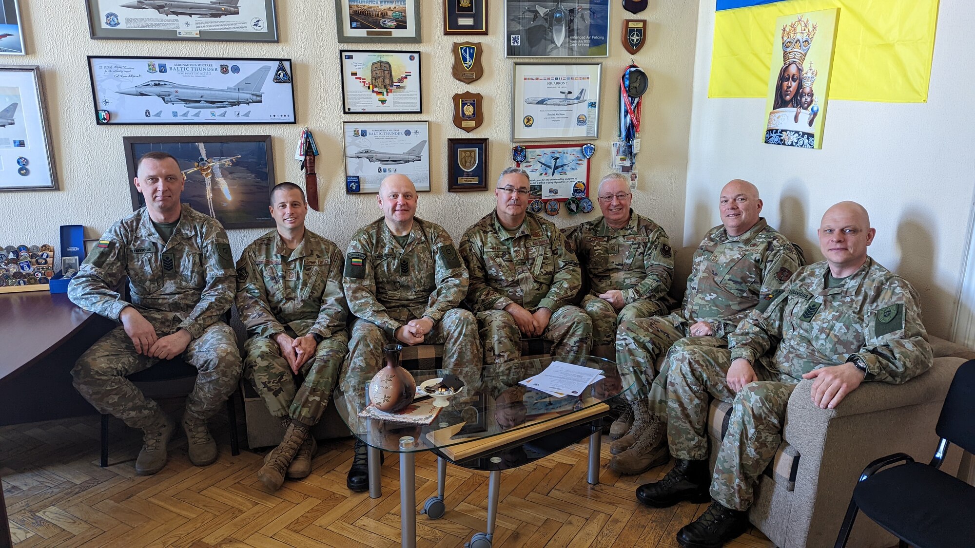 Military men in uniform sitting together.