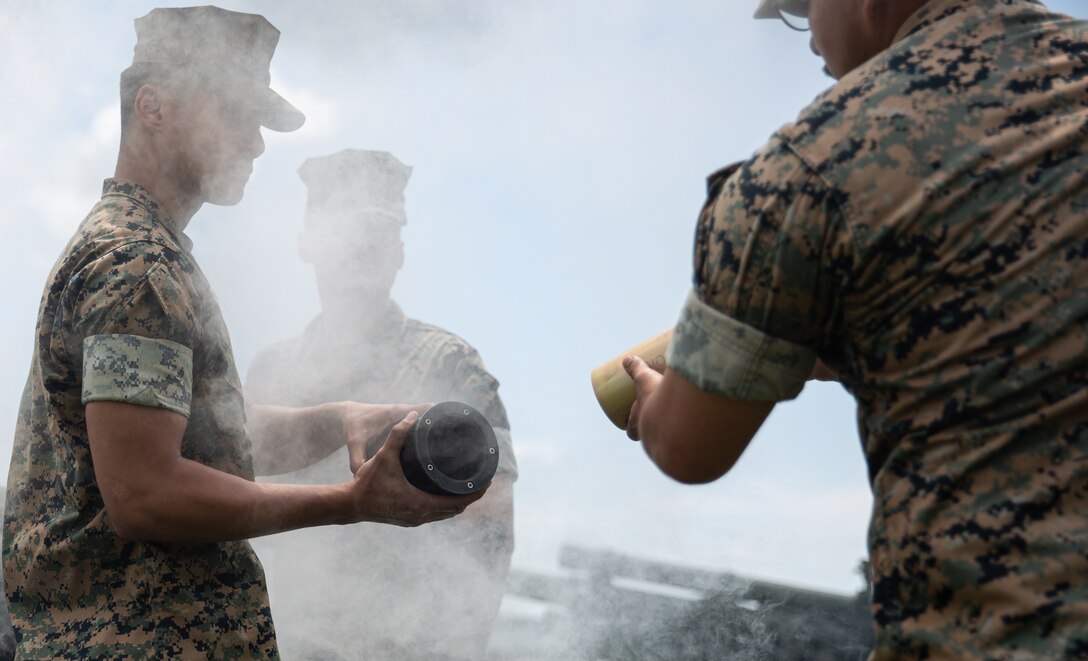 U.S. Marines with Alpha Battery, 1st Battalion, 10th Marine Regiment, 2nd Marine Division, prepare to load an M2A2 Howitzer during a 21-Minute Gun Salute on Marine Corps Base Camp Lejeune, N.C., May 30, 2022. The 21-Minute Gun Salute is a brief ceremony during which guns are discharged 21 times at one-minute intervals in honor of Memorial Day. (U.S. Marine Corps photo by Lance Cpl. Antonino Mazzamuto)