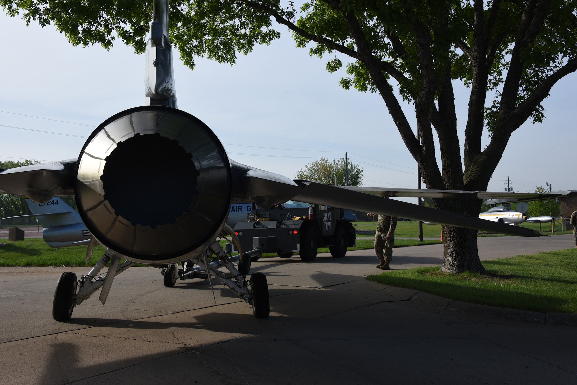 A U.S. Air Force F-16 is removed from static display and moved to paint facility.