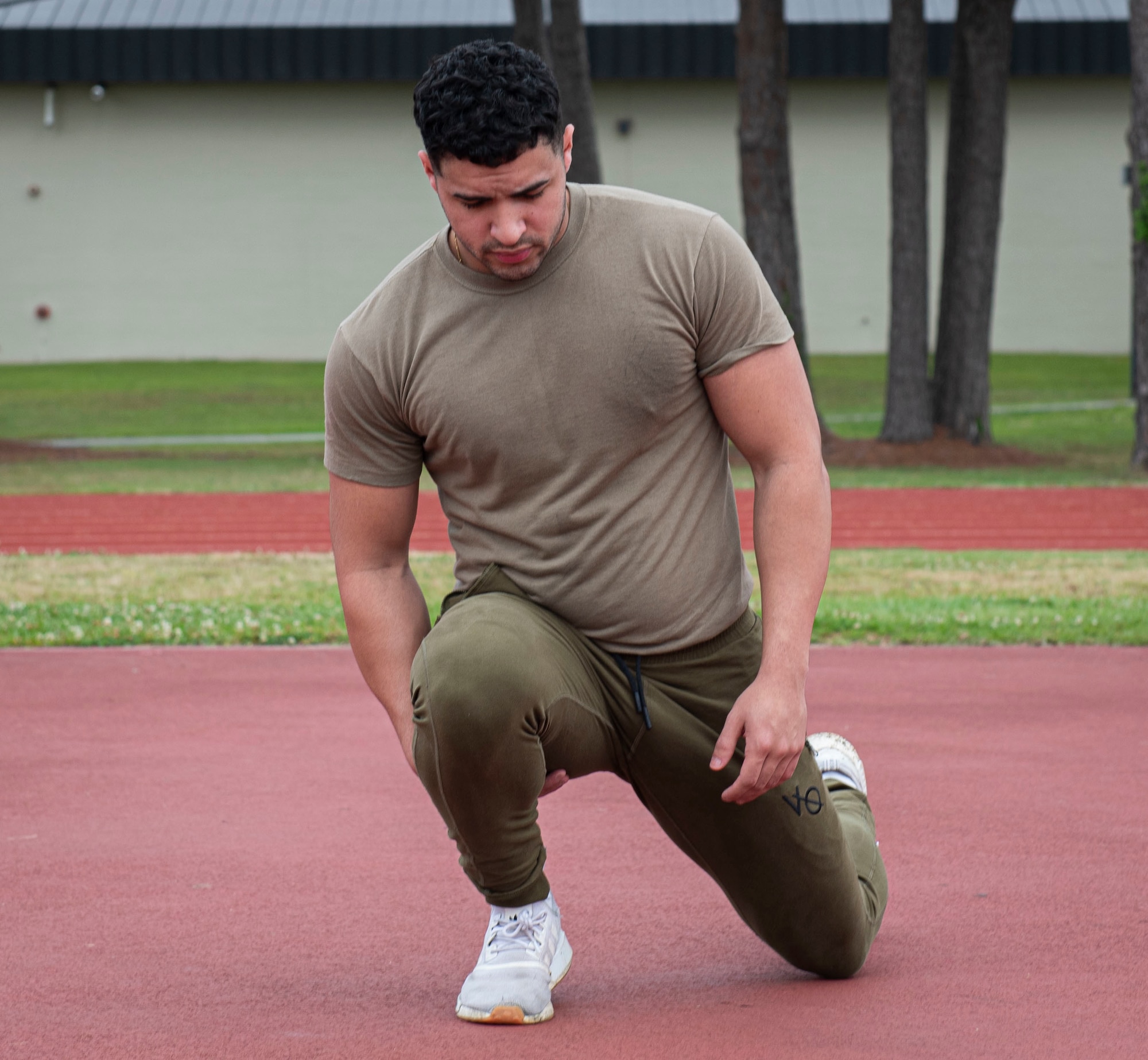 Airman 1st Class Juan Carrasquillo, 334th Fighter Generation Squadron weapons armament system technician, stretches before the start of a Murph Challenge at Seymour Johnson Air Force Base, North Carolina, May 26, 2022. The Murph Challenge was created in memory of Lt. Michael Murphy, U.S. Navy Seal, who was killed in action, but while he was served, he completed this workout to stay physically fit. (U.S. Air Force photo by Airman 1st Class Sabrina Fuller)