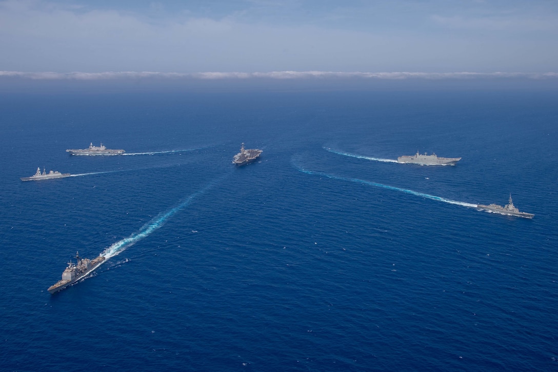 U.S., Italian and Spanish vessels transit a body of water.
