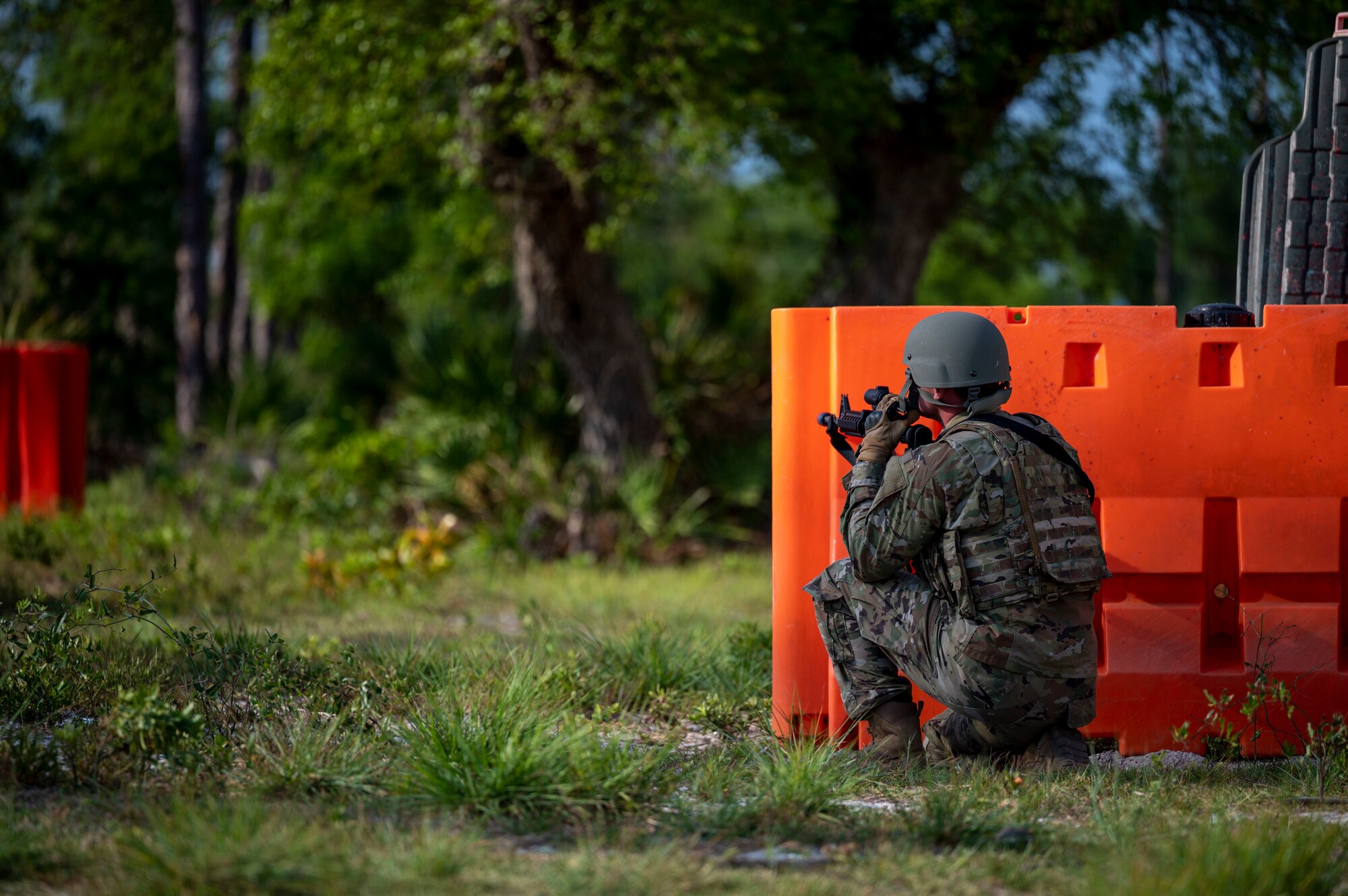 Airman sits behind a barrier