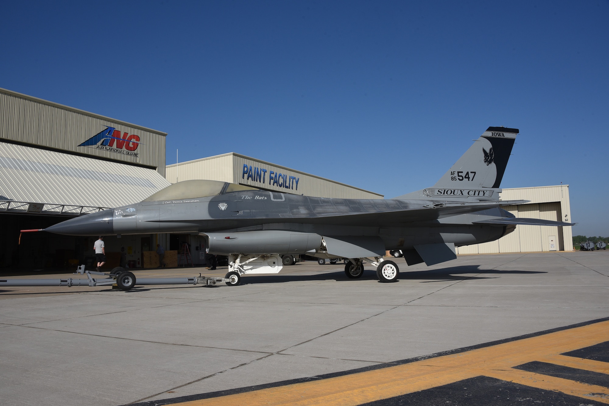 A U.S. Air Force F-16 is removed from static display and moved to the paint facility.