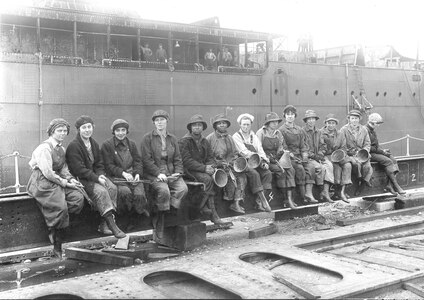 This iconic photograph was taken May 29, 1919. It features women working as rivet heaters and passers at Puget Sound Navy Yard, in Bremerton, Washington, just after the end of World War I. These women foreshadowed the arrival of “Rosie the Riveter” during World War II.