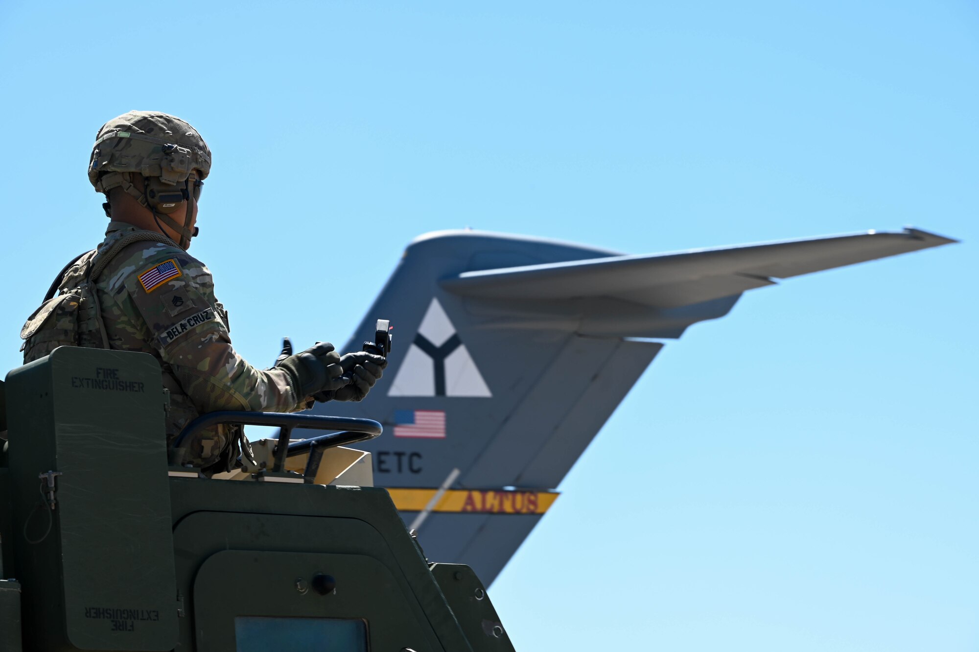 A soldier sits in an M142 High Mobility Artillery Rocket System (HIMARS) at Fort Sill, Oklahoma, May 26, 2022. The HIMARS carries three crew members: the gunner, driver, and launcher chief. (U.S. Air Force photo by Senior Airman Kayla Christenson)