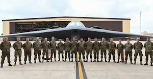 Members of the 509th Aircraft Maintenance Squadron pose for a group photo during the Dedicated Crew Chief induction ceremony at Whiteman Air Force Base, Missouri, May 21, 2022. The DCC induction signifies that the non-commissioned officers assigned to be DCC's have proven that they can maintain and lead other crew members for their assigned B-2 Spirit Bombers. (U.S. Air Force photo by Airman 1st Class Joseph Garcia)