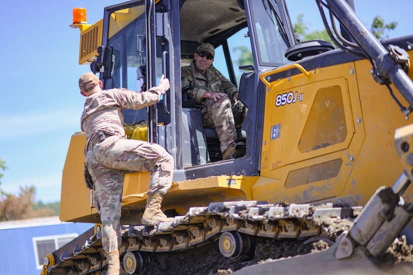 Col. Parkin Bryson, 316th Wing vice commander, sits in a 850J-II Crawler Dozer during bivouac training for 316th and 11th Wing civil engineer Airmen at Fort Indiantown Gap, Pa., May 25, 2022.