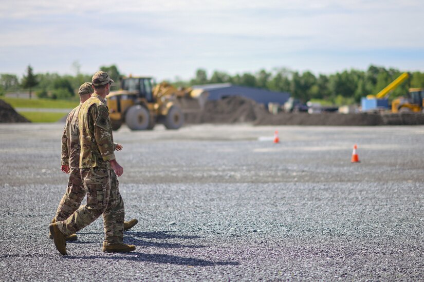 Col. Parkin Bryson, 316th Wing vice commander, Col. Nichole Scott, 316th Mission Support Group commander and Lt. Col Ross Dotzlaf, 316th Civil Engineer Squadron commander, walk alongside a bivouac  training site for civil engineer Airmen at Fort Indiantown Gap, Pa., May 25, 2022.