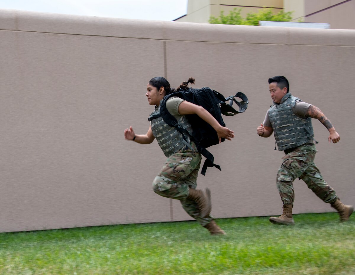 From left to right, U.S. Airman Josefina Toboada-Torres, 60th Dental Squadron dental assistant, and Air Force Senior Airman Min Son, 60th Medical Group medical logistician, run to rescue a simulated victim during tactical combat casualty care training at David Grant USAF Medical Center, Travis Air Force Base, California, April 29, 2022.