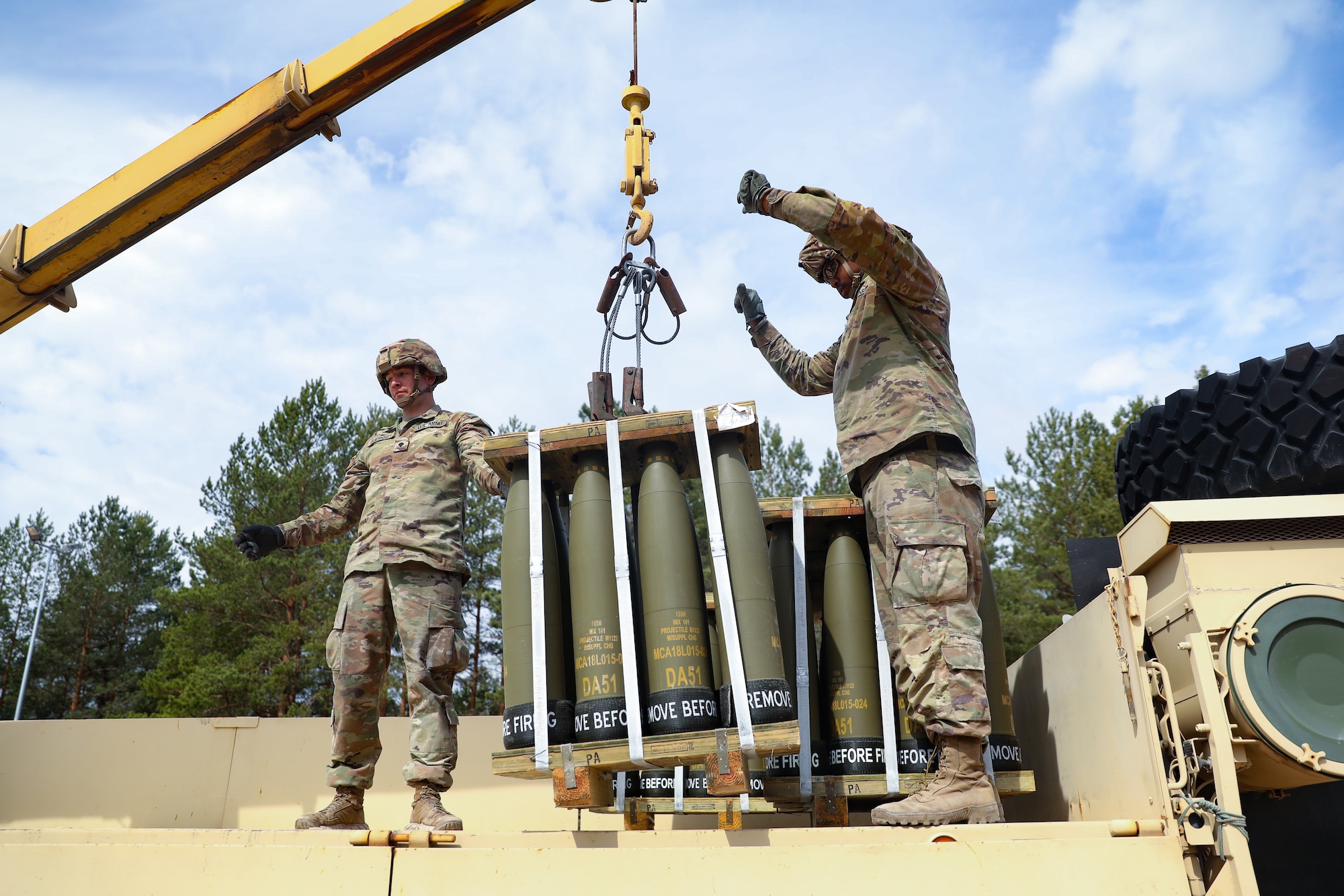 U.S. Army Spc. Jonathan Guernsey, left, and U.S. Army Spc. Khym Wilson, both assigned to the Forward Support Company, 119th Field Artillery Regiment, Michigan Army National Guard, guide the crane operator during Summer Shield at Forward Operating Site Adazi, Latvia, May 19, 2022. Summer Shield is one of U.S. Army Europe and Africa’s multinational training exercises in Eastern Europe that make up Defender Europe 22.