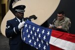 PETERSON SPACE FORCE BASE, Colo. – U.S. Air Force Senior Airman Brandon Whittaker, High Frontier Ceremonial Guardsman, folds an American flag during a Space Delta 3 – Space Electromagnetic Warfare pre-deployment-flag-folding ceremony at Peterson Space Force Base, Colorado, 2022. Flags folded at these ceremonies are flown during deployment by members from DEL 3. DEL 3’s ceremonial tradition of folding flags to bring on deployment, dates back over 20 years to the 76th Space Control Squadron. (U.S. Space Force Photo by Airman 1st Class Aaron Edwards)