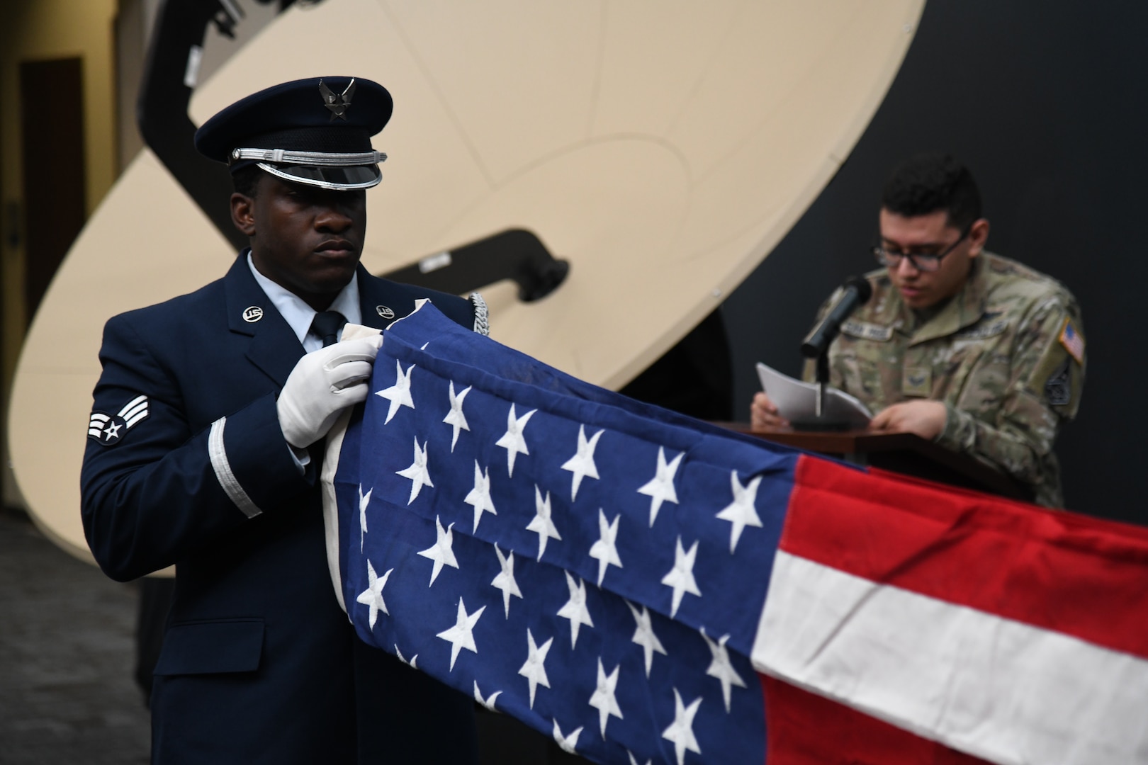 PETERSON SPACE FORCE BASE, Colo. – U.S. Air Force Senior Airman Brandon Whittaker, High Frontier Ceremonial Guardsman, folds an American flag during a Space Delta 3 – Space Electromagnetic Warfare pre-deployment-flag-folding ceremony at Peterson Space Force Base, Colorado, 2022. Flags folded at these ceremonies are flown during deployment by members from DEL 3. DEL 3’s ceremonial tradition of folding flags to bring on deployment, dates back over 20 years to the 76th Space Control Squadron. (U.S. Space Force Photo by Airman 1st Class Aaron Edwards)