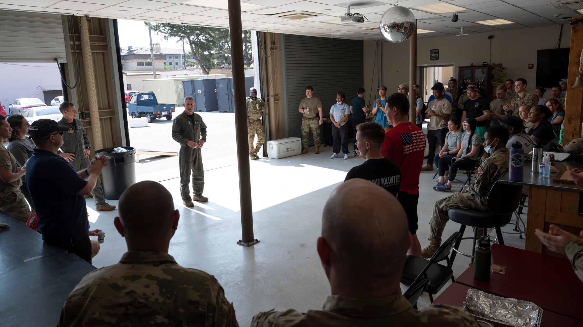 A Colonel speaks to a group of Airmen.