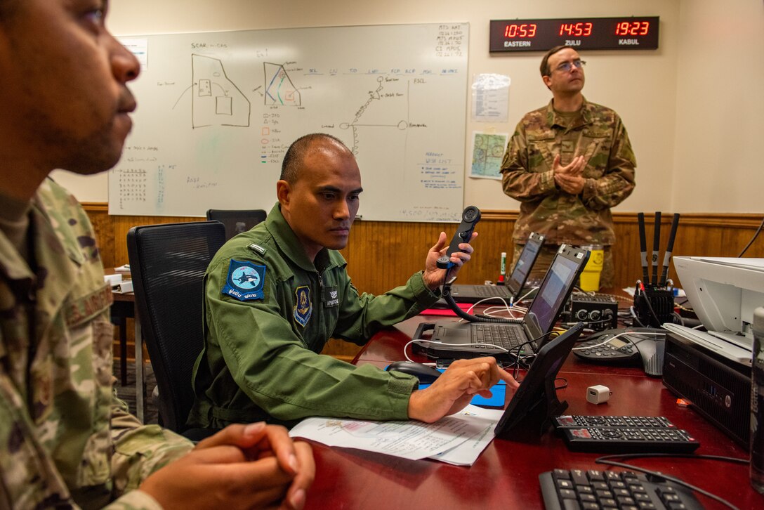 U.S. Air Force Tech. Sgt. Matthew Harris, 81st Fighter Squadron experiment mobile data manager, supervises Airborne Extensible Relay Over-Horizon Network integration for Royal Thai Air Force Flying Officer Apisit Kitchoke at Moody Air Force Base, Georgia, April 13, 2022. In an effort to support Air Combat Command’s initiative of advancing partnering nations interoperability, Team Moody is working with military members from Colombia, Thailand, Nigeria and Tunisia in AERONet capabilities.  (U.S. Air Force photo by Airman 1st Class Courtney Sebastianelli)