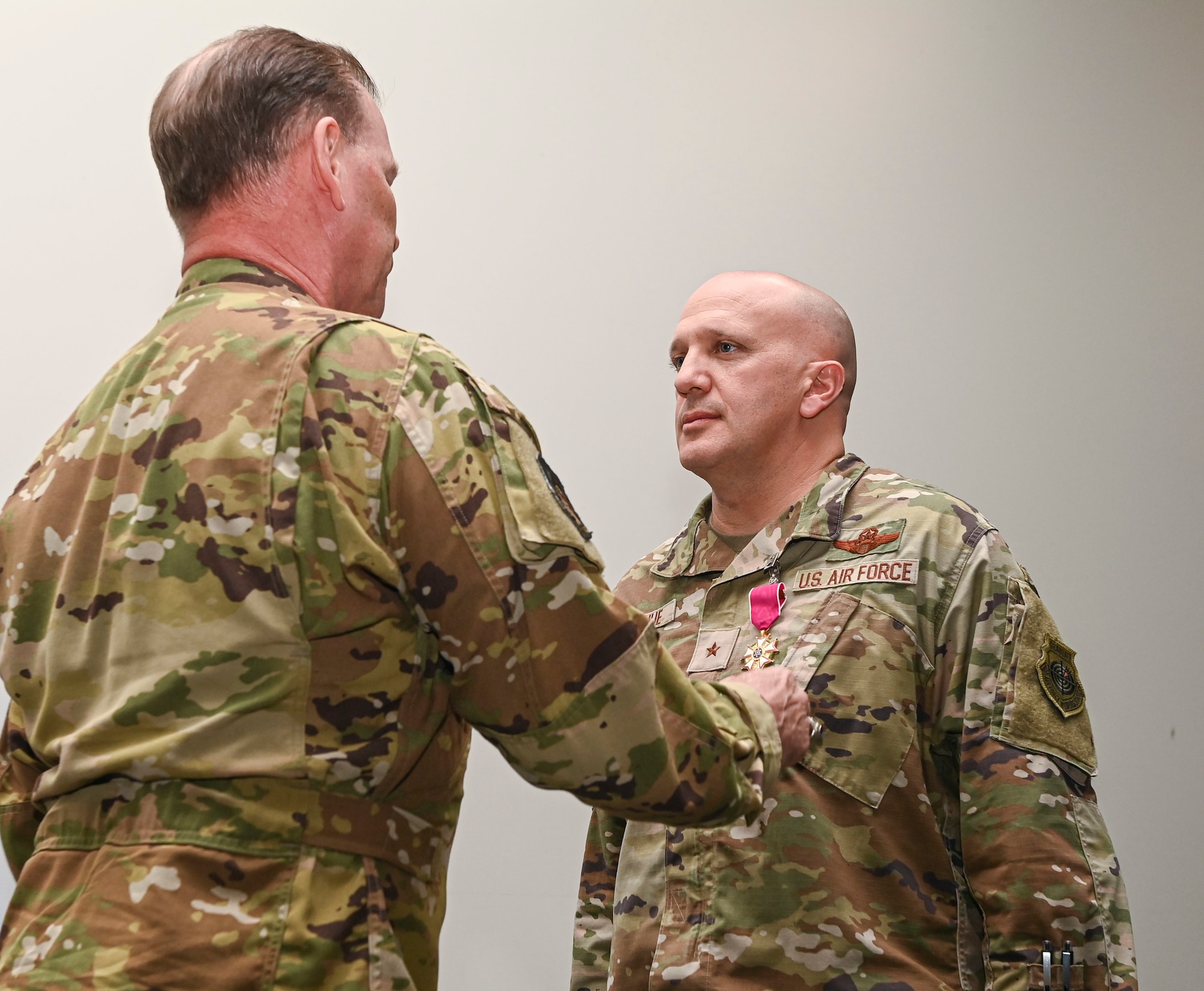 U.S. Air Force Brig. Gen. Gerald Donohue, outgoing 379th Air Expeditionary Wing commander, is awarded the Legion of Merit, Second Oak Leaf Cluster, by U.S. Air Force Maj. Gen. David Meyer, Ninth Air Force deputy commander, during the official wing Change of Command ceremony May 30, 2022, at Al Udeid Air Base, Qatar. Donohue had served as the 379th AEW commander since June 2021. (U.S. Air National Guard photo by Tech. Sgt. Michael J. Kelly)