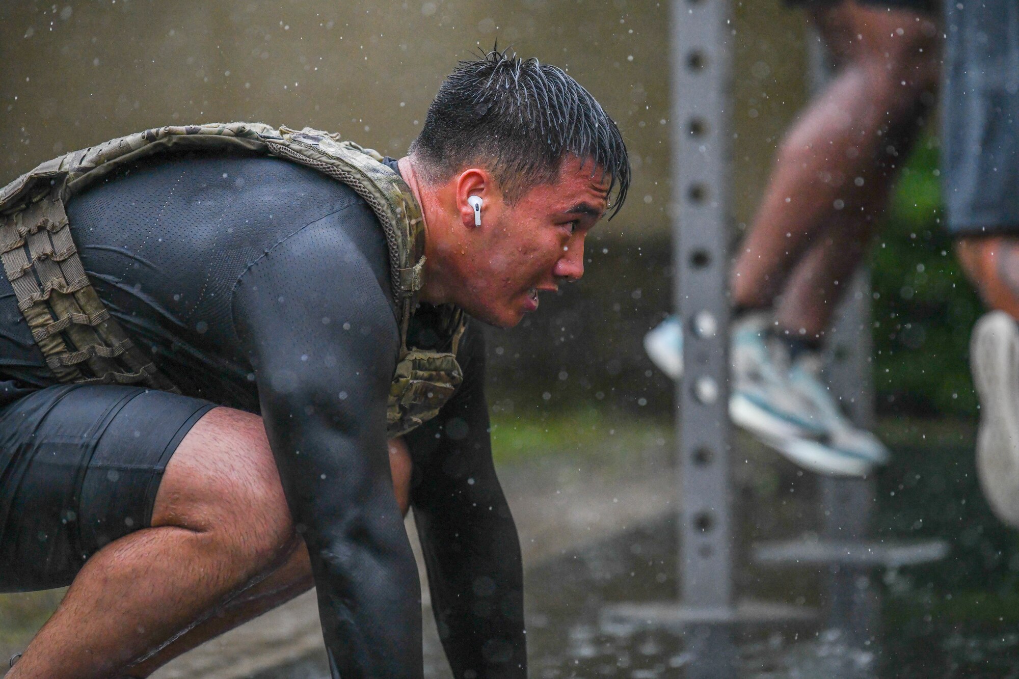 Senior Airman Richard Van, 374th Security Forces Squadron electronic security systems noncommissioned officer in charge, performs squats during a Murph challenge, at Yokota Air Base, Japan, May 27, 2022. The Murph challenge consists of 100 pull-ups, 200 push-ups, 300 squats and a mile run before and after the repetitions, with or without a weighted vest. (U.S. Air Force photo by Staff Sgt. Jessica Avallone)