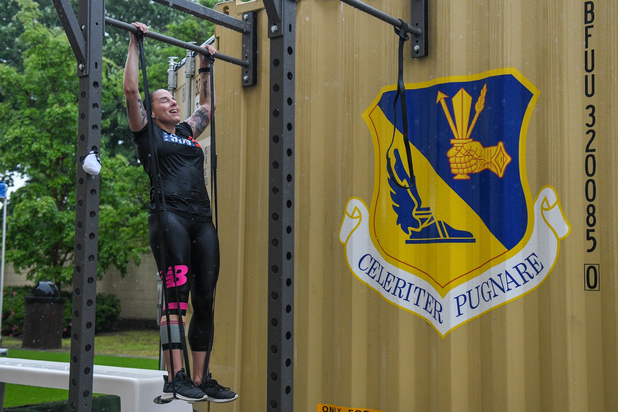 Senior Master Sgt. Denielle Hilliard, 374th Force Support Squadron sustainment services superintendent, performs pull-ups during a Murph challenge, at Yokota Air Base, Japan, May 27, 2022. The challenge coincided with a box gym grand opening at the base natatorium. (U.S. Air Force photo by Staff Sgt. Jessica Avallone)