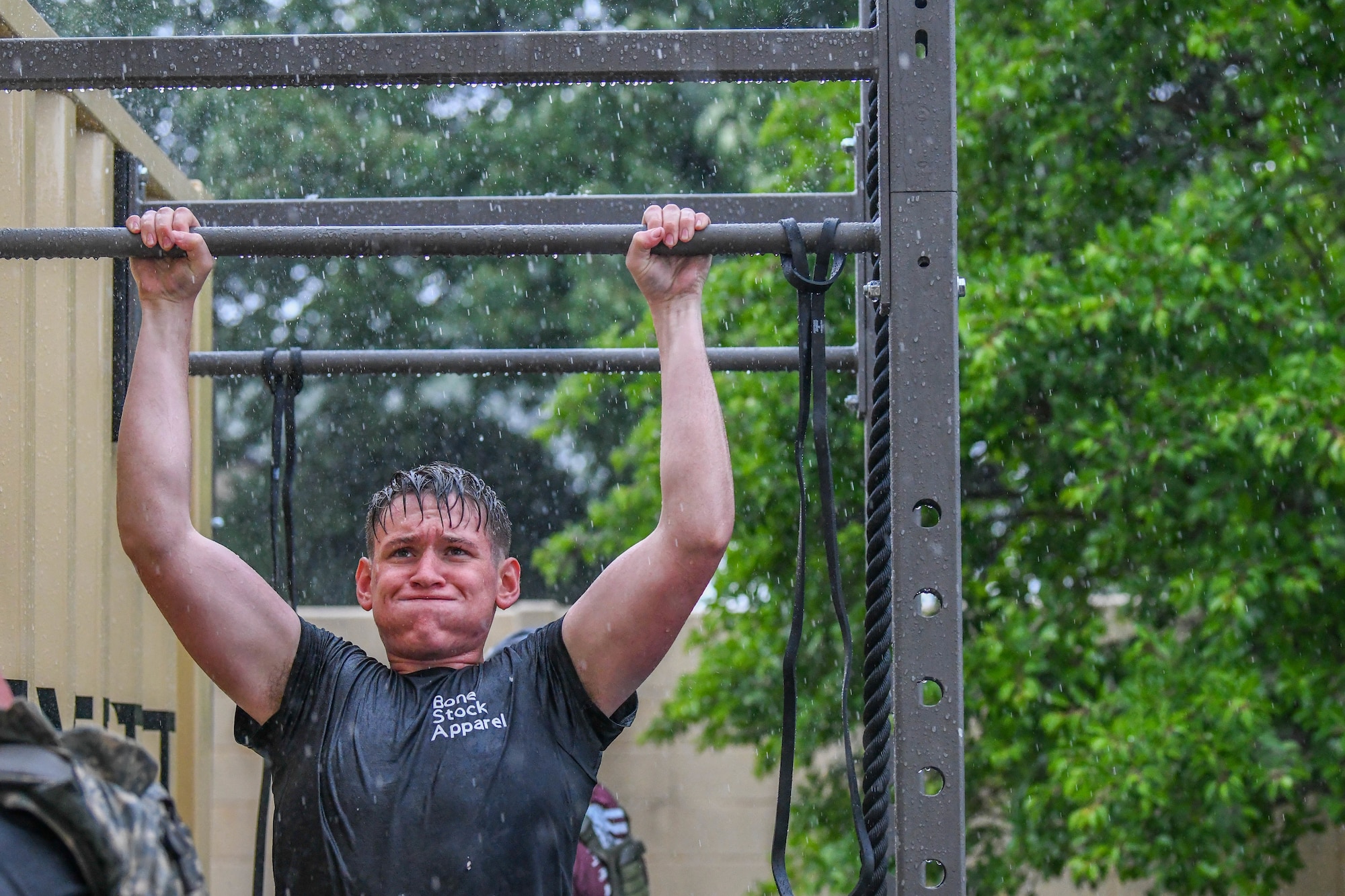 A fitness enthusiast performs pull-ups during a Murph challenge at Yokota Air Base, Japan, May 27, 2022. The Murph challenge memorializes U.S. Navy SEAL Lt. Michael P. Murphy who received the Medal of Honor for his actions during the war in Afghanistan. He was the first member of the United States Navy to receive the award since the Vietnam War. (U.S. Air Force photo by Staff Sgt. Jessica Avallone)