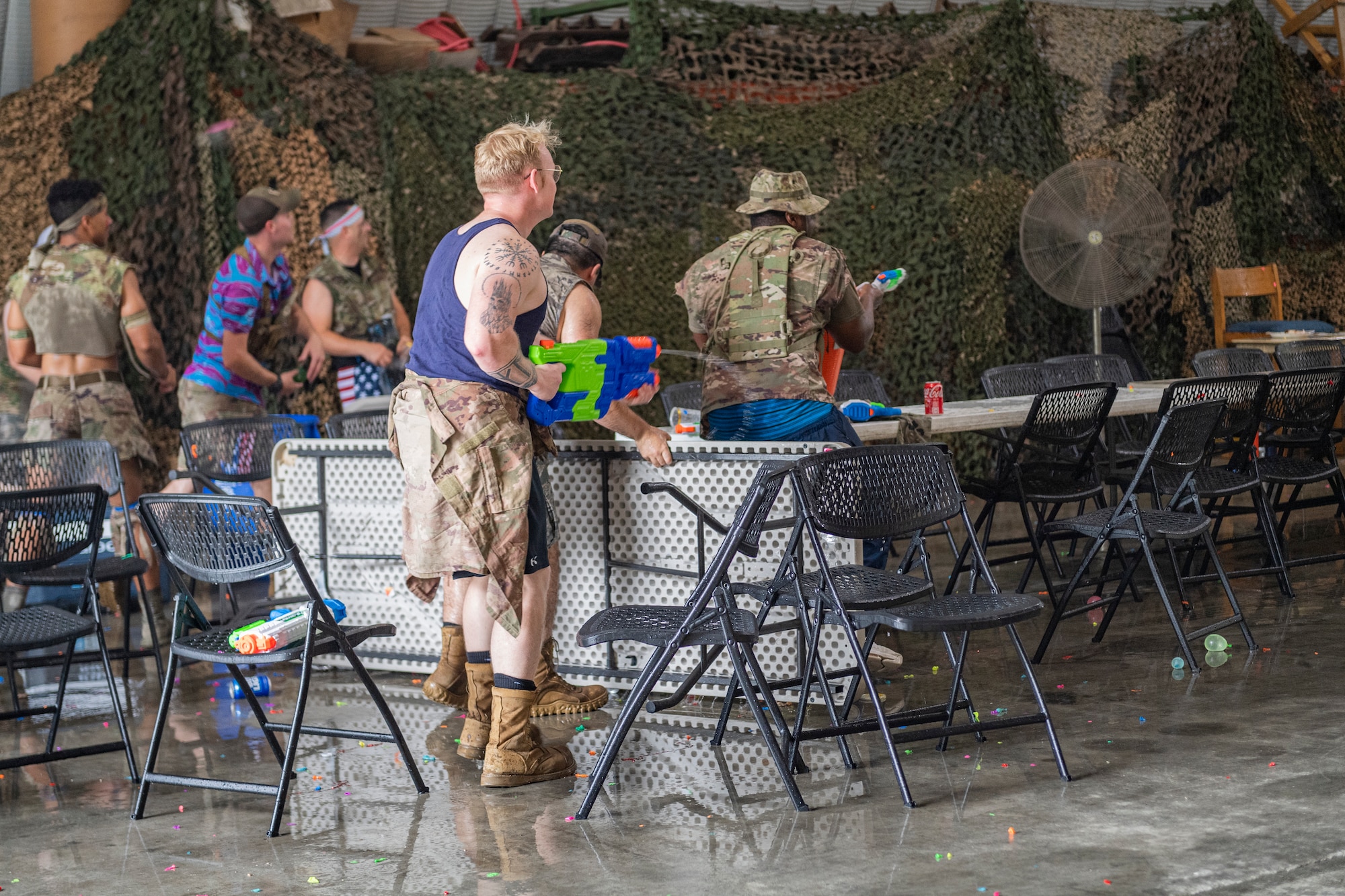Photo of Airmen participating in a water fight