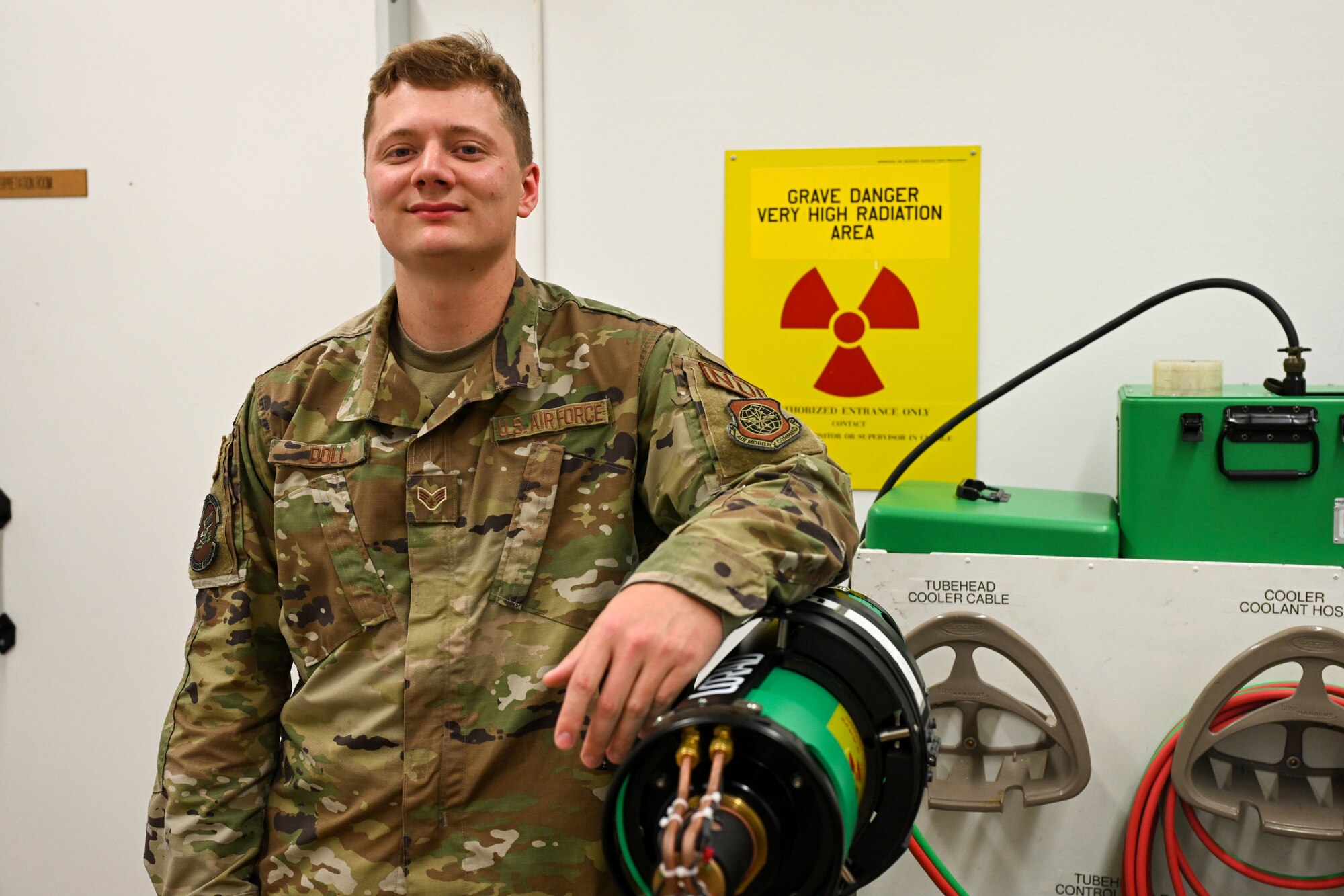 An Airman stands next to non-destructive inspection equipment.