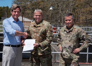 Converge LLC founder and Managing Partner, Matthew Kennedy shakes hands with  Col. Sean Riley, 102nd Intelligence Wing Commander upon the transfer of ownership of the Joint Base Cape Cod water and wastewater systems to Converge LLC. This comes after over two years of negotiations between the Company, the Massachusetts Air National Guard and the United States Air Force. The systems have been under the management and control of the Massachusetts Air National Guard since the operations of the base’s infrastructure were transferred to it by the Air Force in the mid-1970’s.
