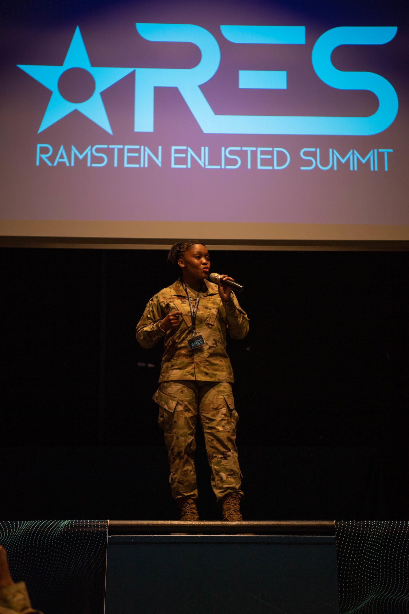 U.S. Air Force 86th Airlift Wing Command Chief Master Sgt. Charmaine N. Kelley, welcomes members of the Kaiserslautern Military Community and geographically separated units, who gathered for an Enlisted Summit at the Hercules Theater at Ramstein Air Base, Germany, May 24, 2022.