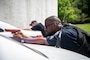 Naval District Washington security forces officers aims imitation firearms during an anti-terrorism training exercise onboard Naval Support Facility Carderock.