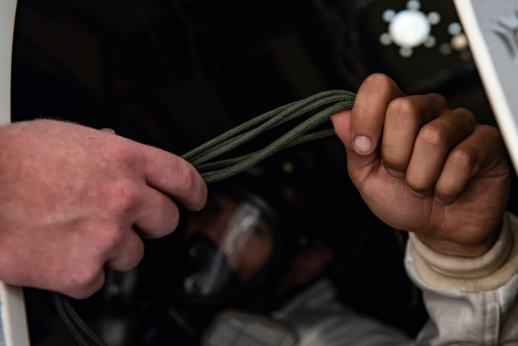 An Airman is handed lacing cords.