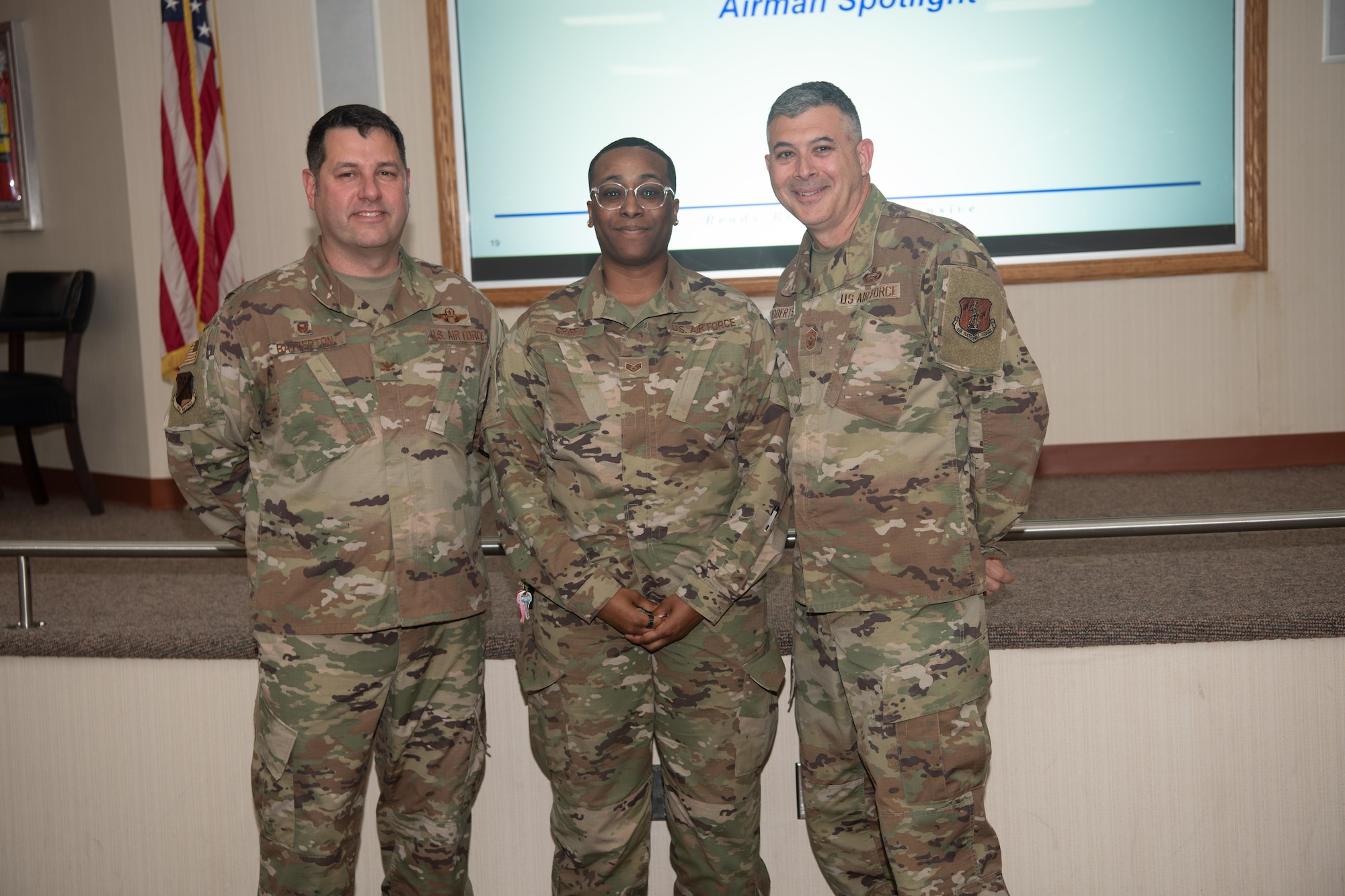 From left, Col. Christopher G. Batterton, 192nd Wing commander, Staff Sgt. Victoria Griffin, 203rd RED HORSE, and Chief Master Sgt. Richard Roberts, 192nd Wing command chief, pose for a photo.