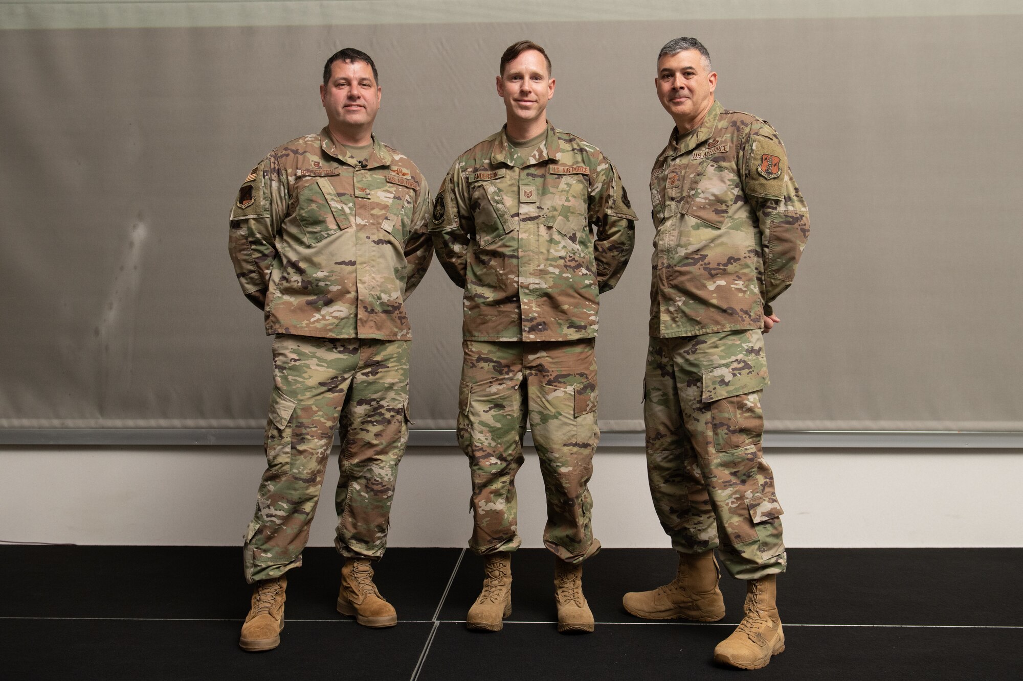 From left, Col. Christopher G. Batterton, 192nd Wing commander, Tech. Sgt. Jason Anderson, 192nd Maintenance Squadron test cell certifier, and Chief Master Sgt. Richard Roberts, 192nd Wing command chief, pose for a photo.