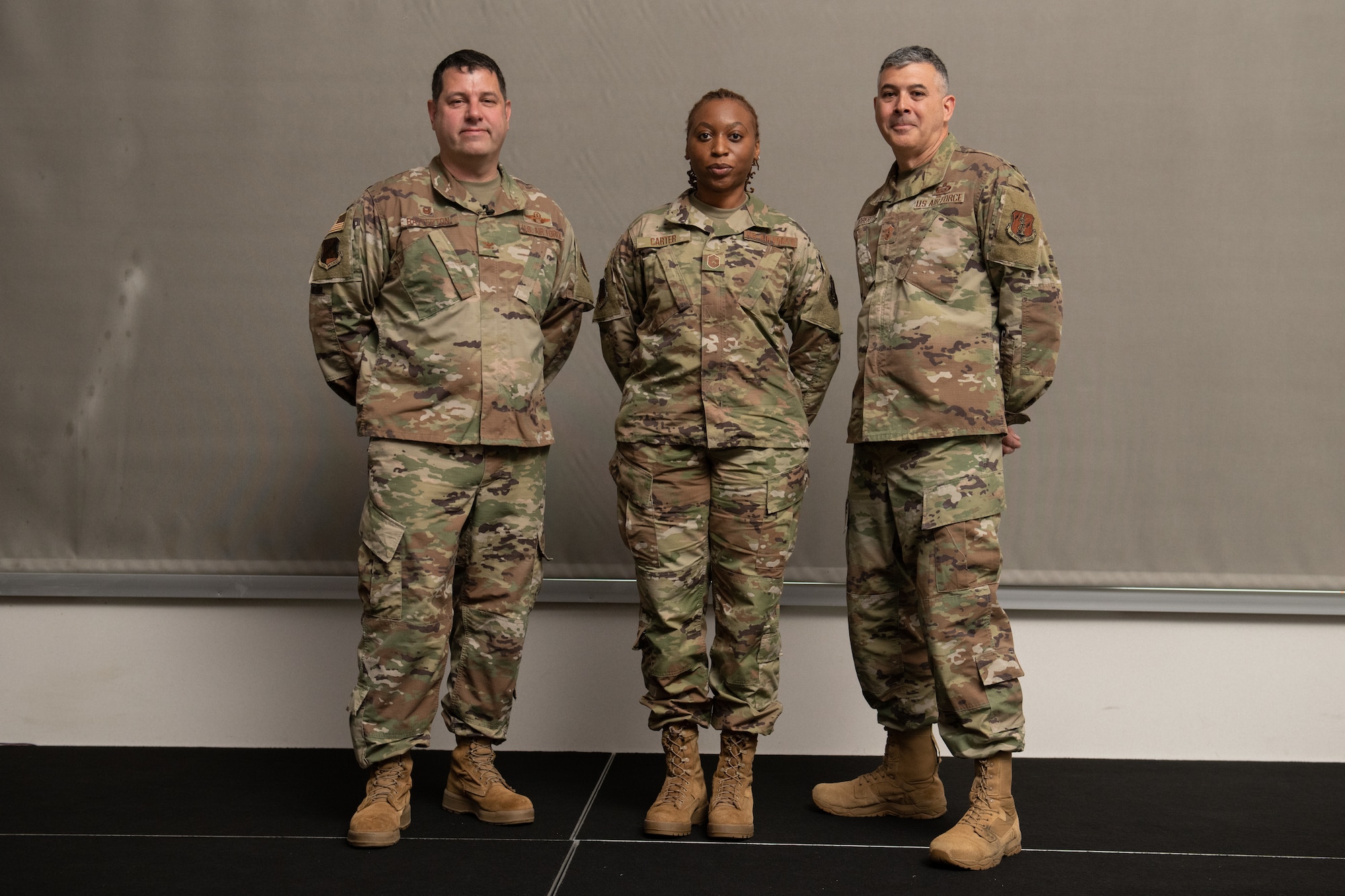 From left, Col. Christopher G. Batterton, 192nd Wing commander, Master Sgt. Christin Carter, 192nd Medical Group bioenvironmental engineering technician, and Chief Master Sgt. Richard Roberts, 192nd Wing command chief, pose for a photo.