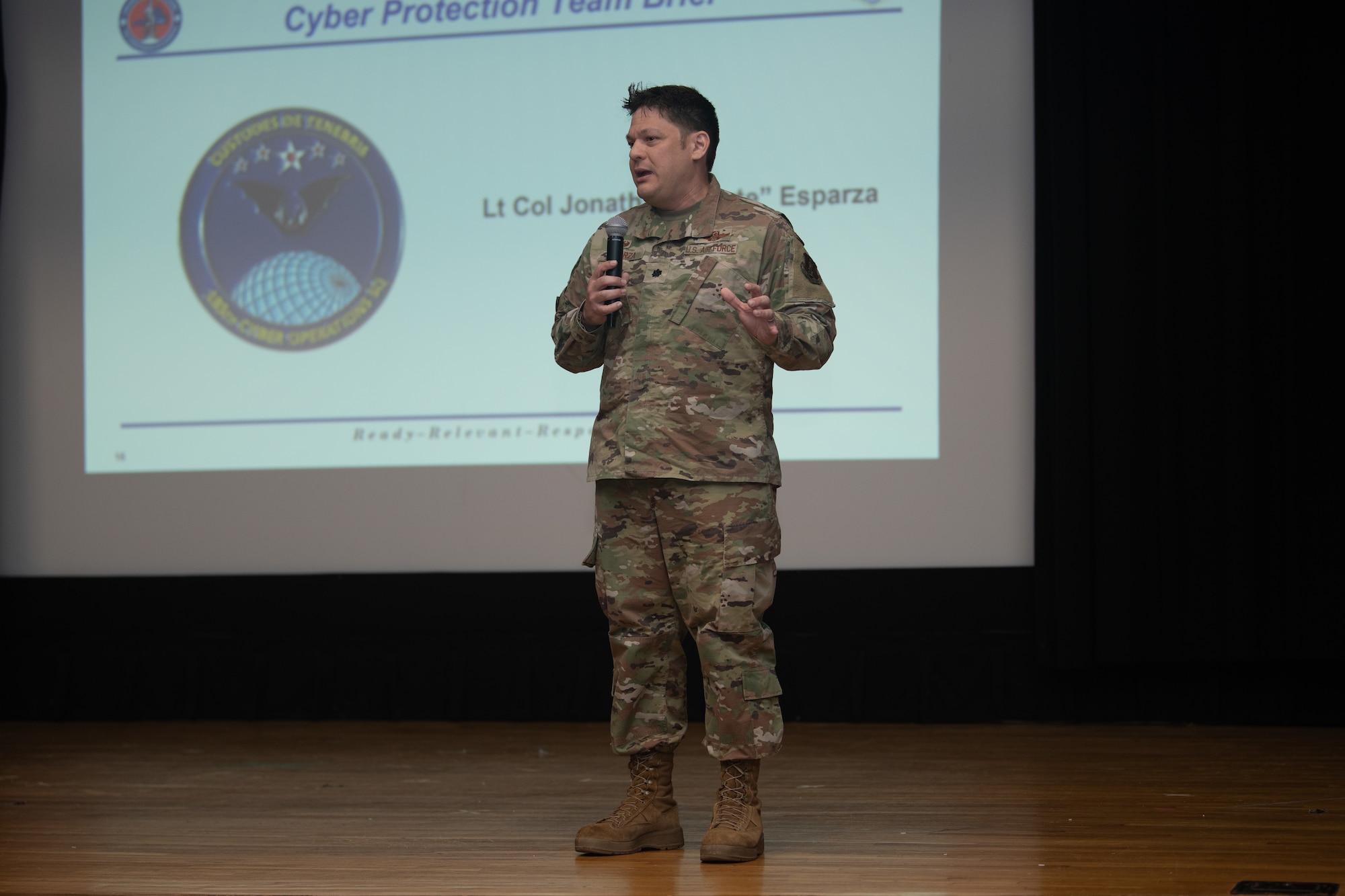 Lt. Col. Jonathan Esparza, 192nd Cyberspace Operations Squadron commander, speaks on stage.