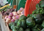 Fresh vegetables in baskets on sale at a farmers market.