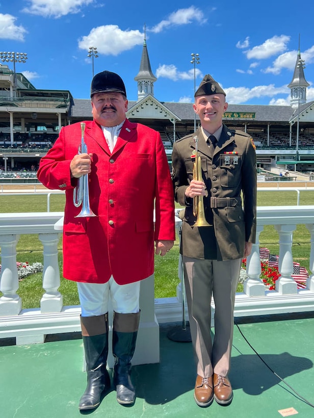 Spc. Anthony Rayburn, 223rd Military Police Company, and Steve Buttleman, the official bugler of Churchill Downs and the Kentucky Derby, play Taps on Memorial Day at Churchill Downs in Louisville, Ky., May 30, 2022. Rayburn was inspired to learn the bugle after Buttleman played for the group of young Boy Scouts in 2010.