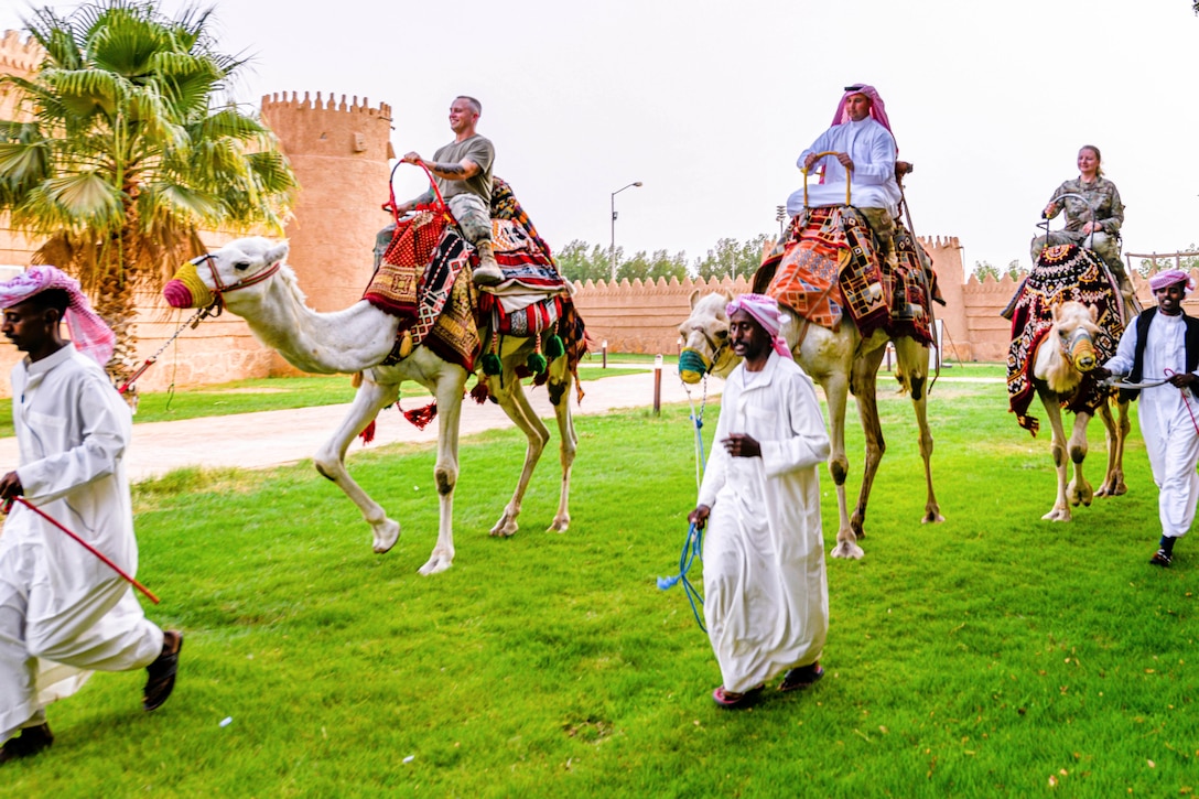 U.S. service members ride camels at a Prince Sultan Air Base Museum.