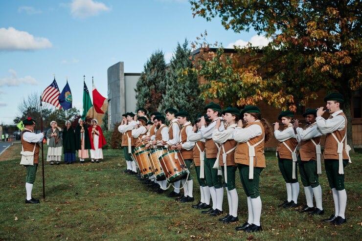 Photo of the Hanaford's Fife and Drum performing outside of the Vermont Air National Guard's headquarters burlington at the 158th Fighter Wing.