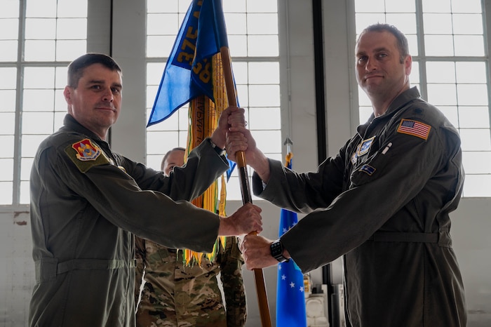Airman hands guidon to other Airman
