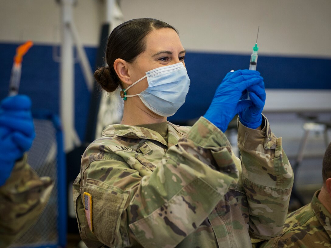 Soldier fills medical syringe