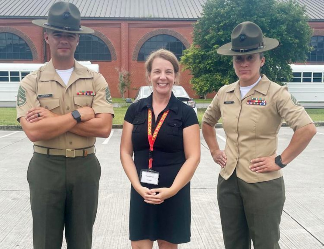 U.S. Marine Corps Drill Instructor Staff Sgt. Forrest Johnson, left, Stacy Purcell, a life coach and volunteer for young adults from Appomattox County, and U.S. Marines Corps Drill Instructor Staff Sgt. Evelyn Espinal, right, pose for a photo during the annual Educators’ Workshop on Marine Corps Base Parris Island, South Carolina, August 6, 2021. Marine Corps Recruiting Command conducts educator workshops annually to inform high school educators, coaches, and counselors about the process of becoming a Marine and raise awareness of the opportunities for their students in the Corps. (U.S. Marine Corps courtesy photo)