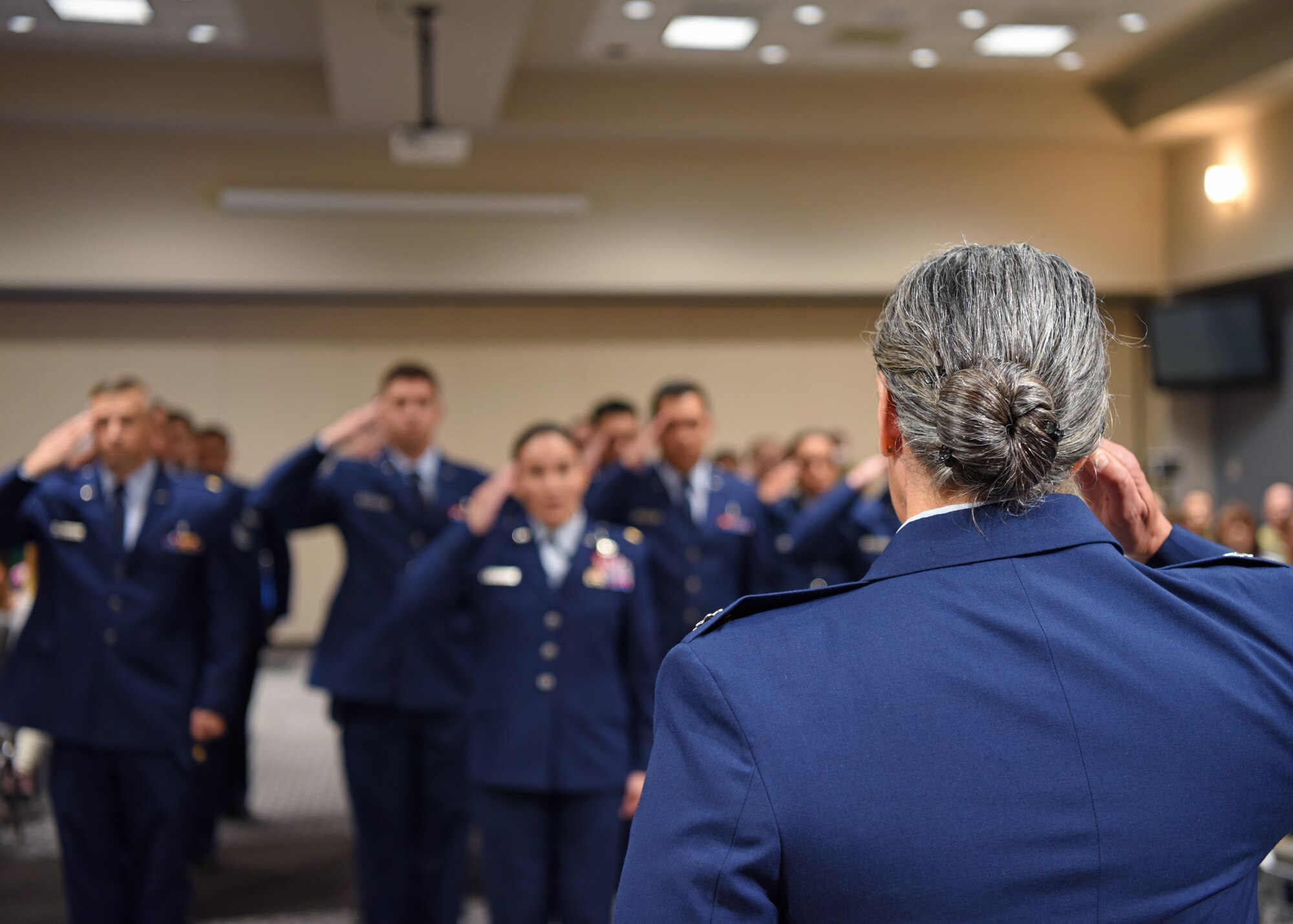 U.S. Air Force Lt. Col. Brenda Miazga, 17th Operational Medical Readiness Squadron incoming commander, salutes the 17th OMRS flight at the 17th OMRS change of command ceremony at the Powell Event Center, June 2, 2022. Miazga assumed command from Col. Roy Louque who is moving to Nellis Air Force Base. (U.S. Air Force photo by Senior Airman Ethan Sherwood)